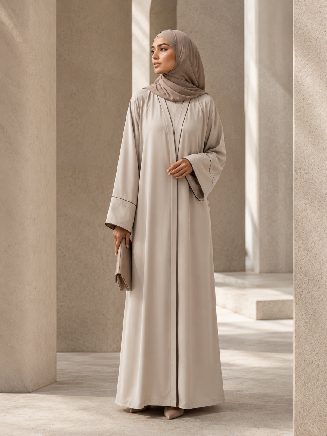 Precisely tailored neutral abaya with balanced sleeves and clean vertical construction