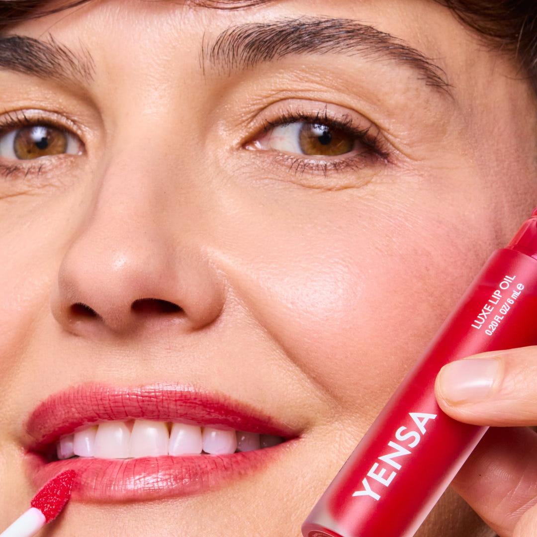 Model wearing YENSA Luxe Lip Oil in Rising Ruby