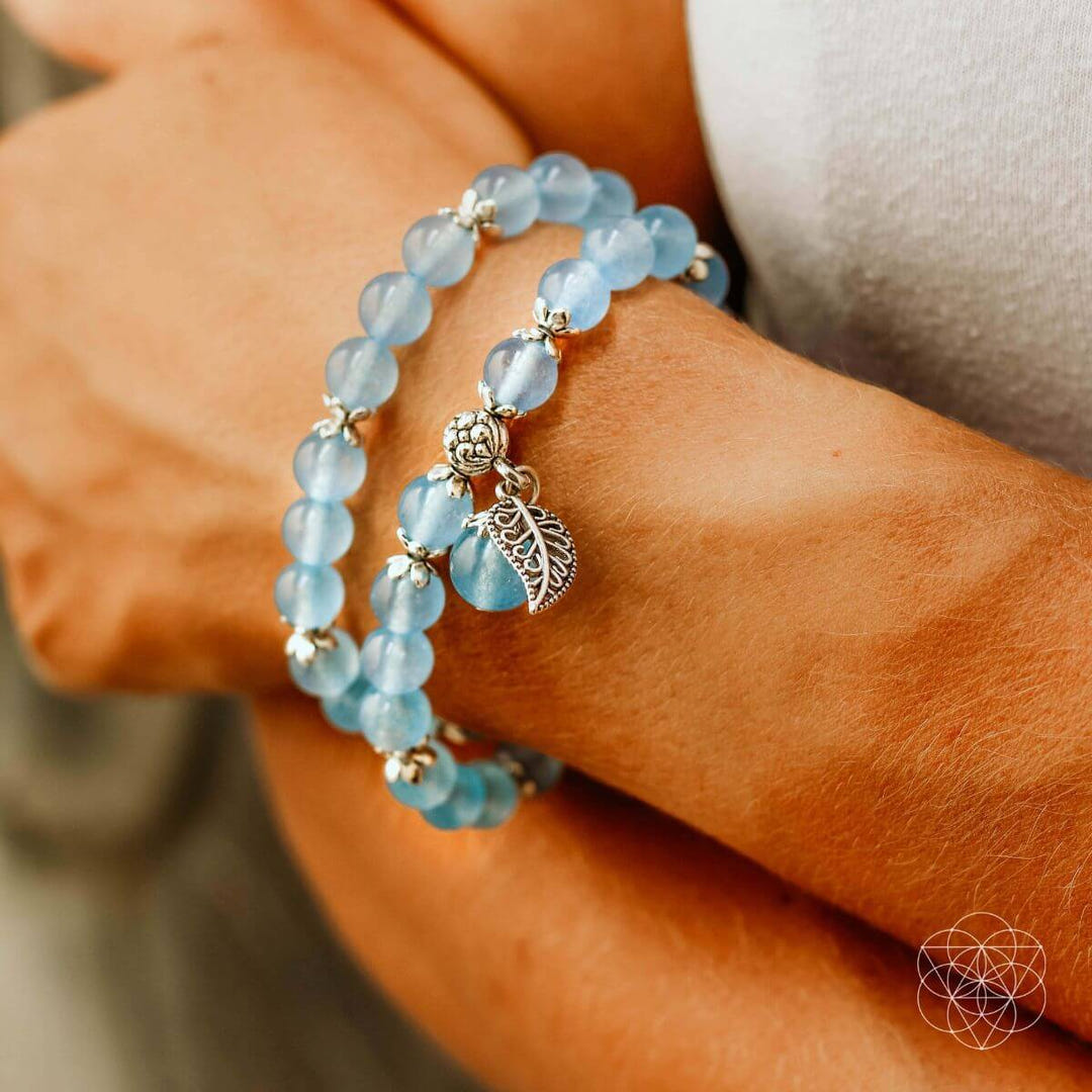 Long elastic chalcedony bracelet shown as layered wristwear