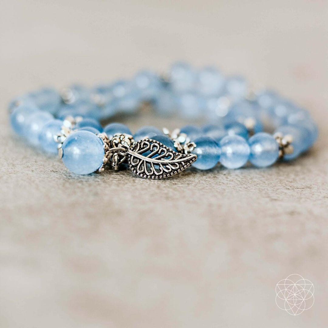 Blue chalcedony beads and alloy leaf charm close-up
