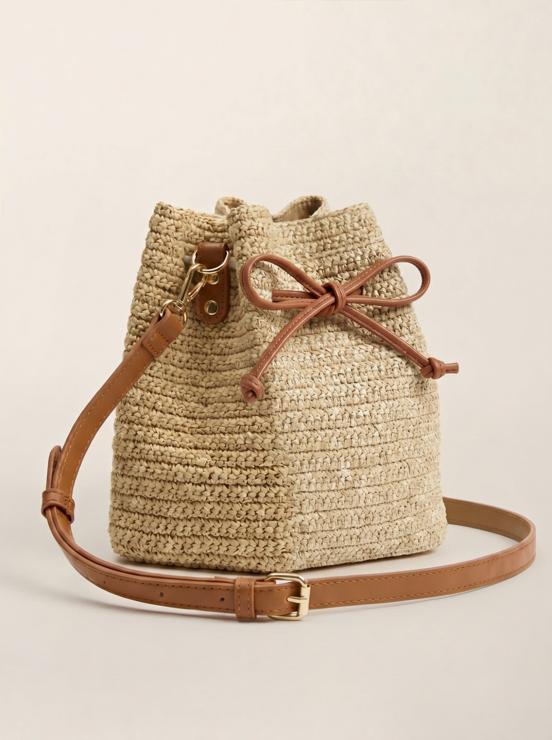 Mini raffia drawstring crossbody bag in Honey Sand