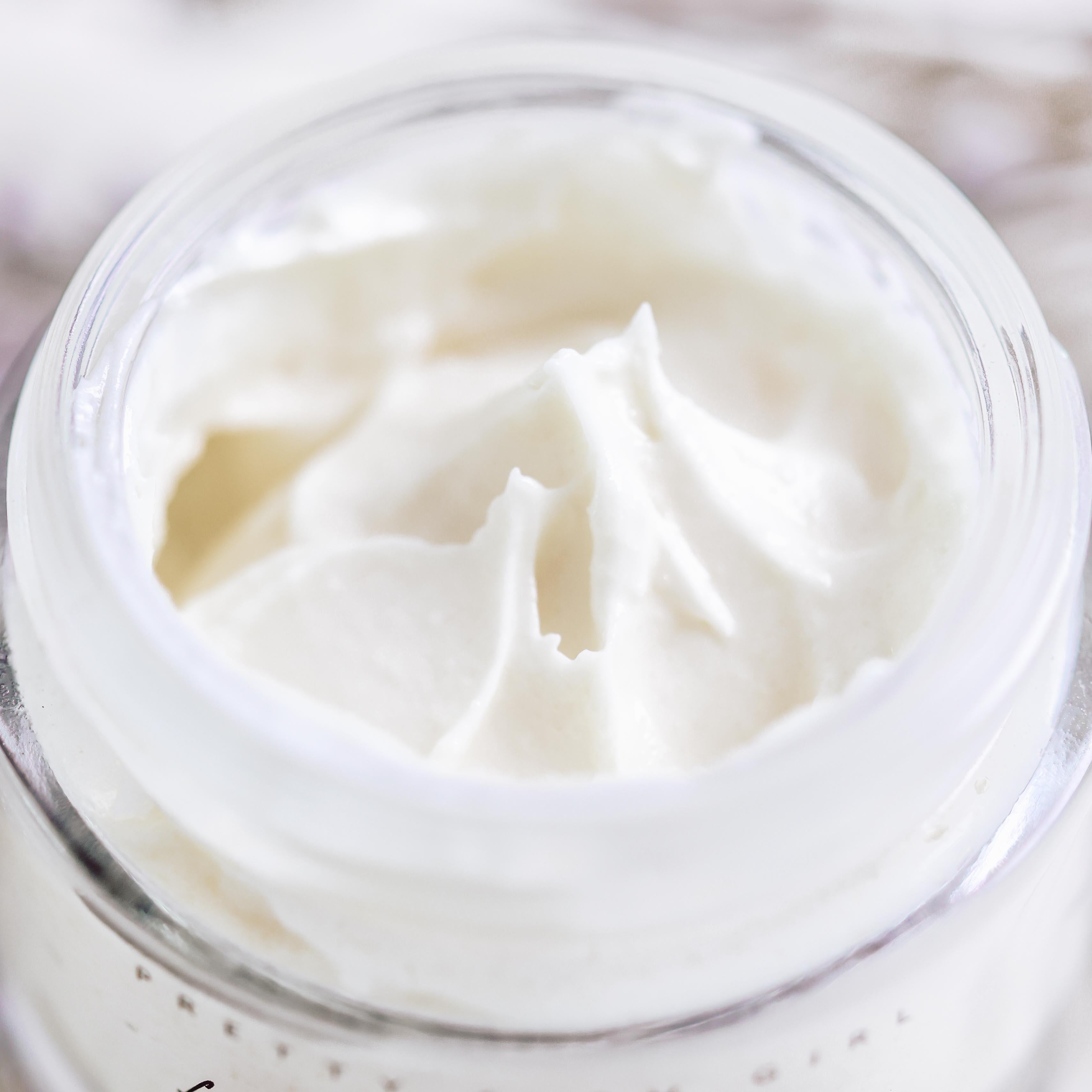 Top view of Fresh Face tallow cream in an open glass jar