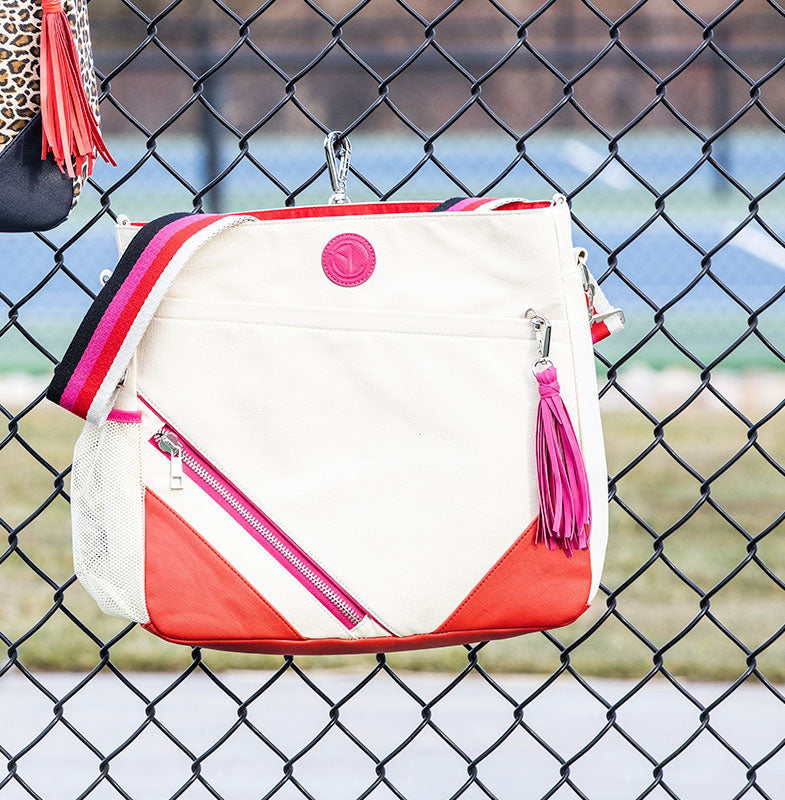 Parker pickleball bag attached to a court fence