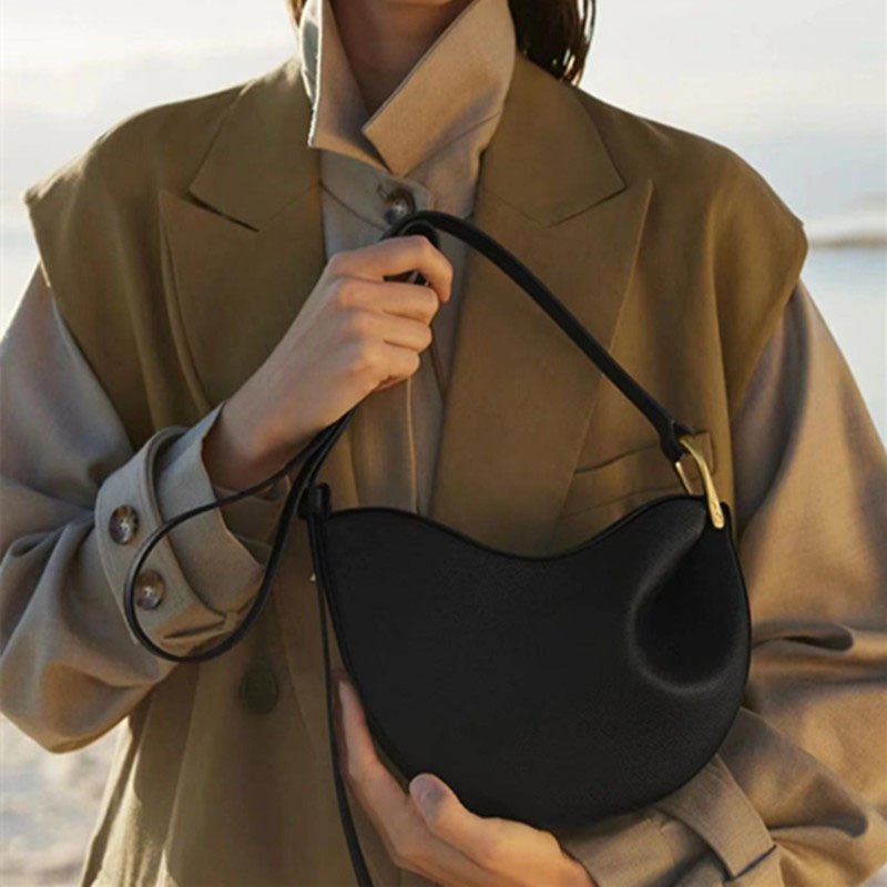 Lychee-texture saddle crossbody bag with curved profile
