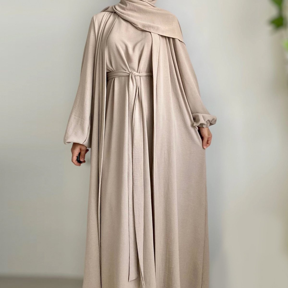 Three-piece open abaya layered over a coordinated inner dress with a clean visible base