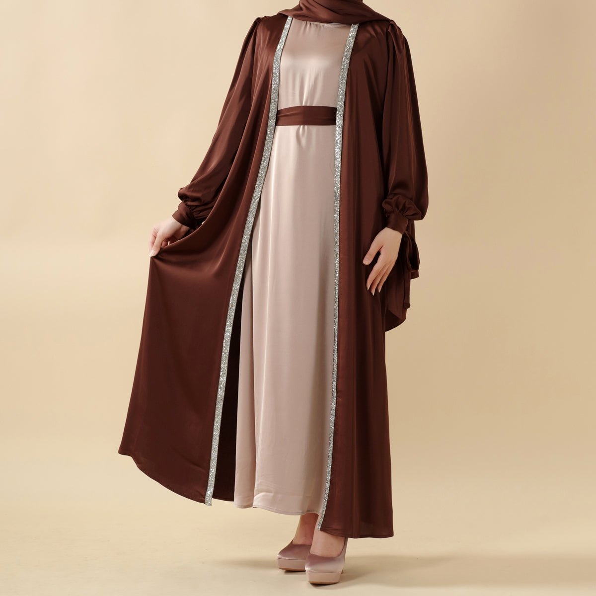 Open abaya with bow-tie sleeves layered over a coordinated full-length inner dress