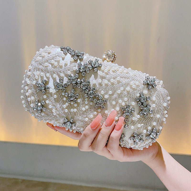 Structured evening clutch with rhinestone detail and hidden chain strap