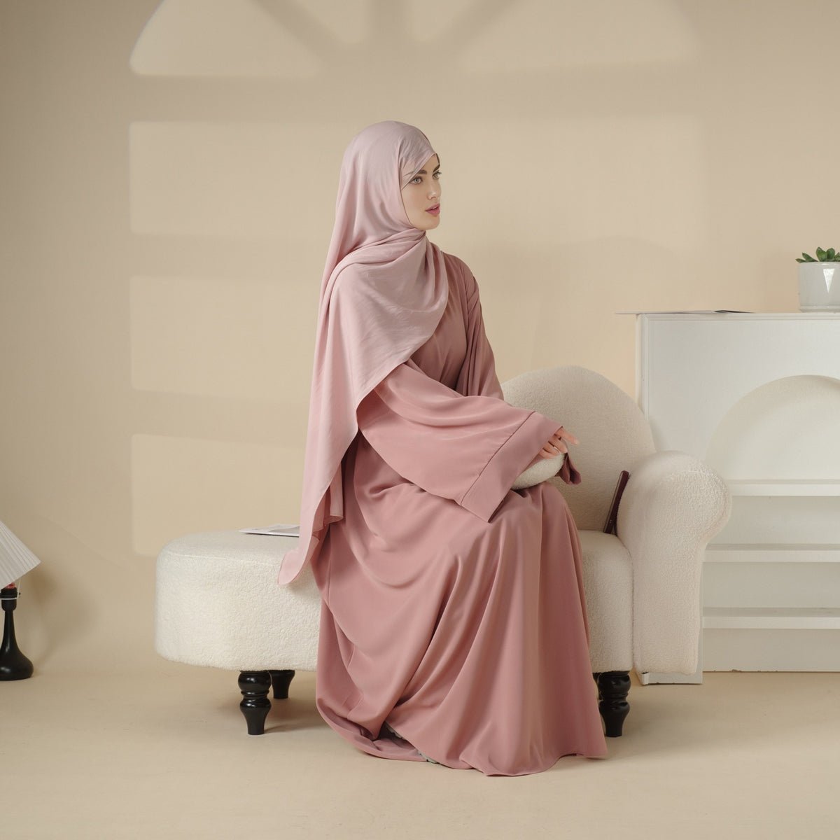 Smooth Nida abaya and belt set demonstrating a clean low-bulk layering profile