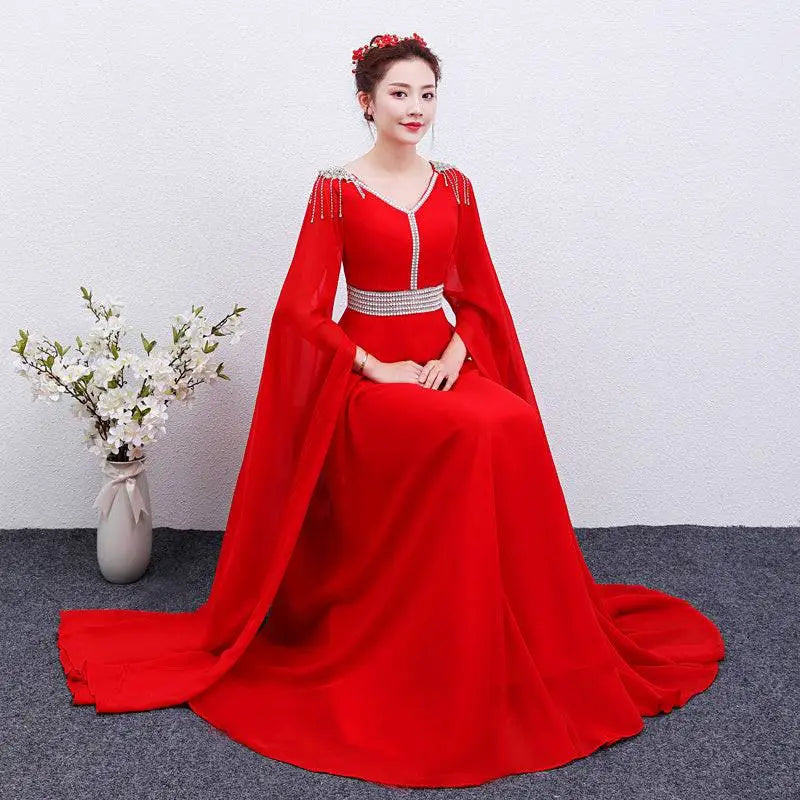 Red cape-sleeve gown with embellished neckline